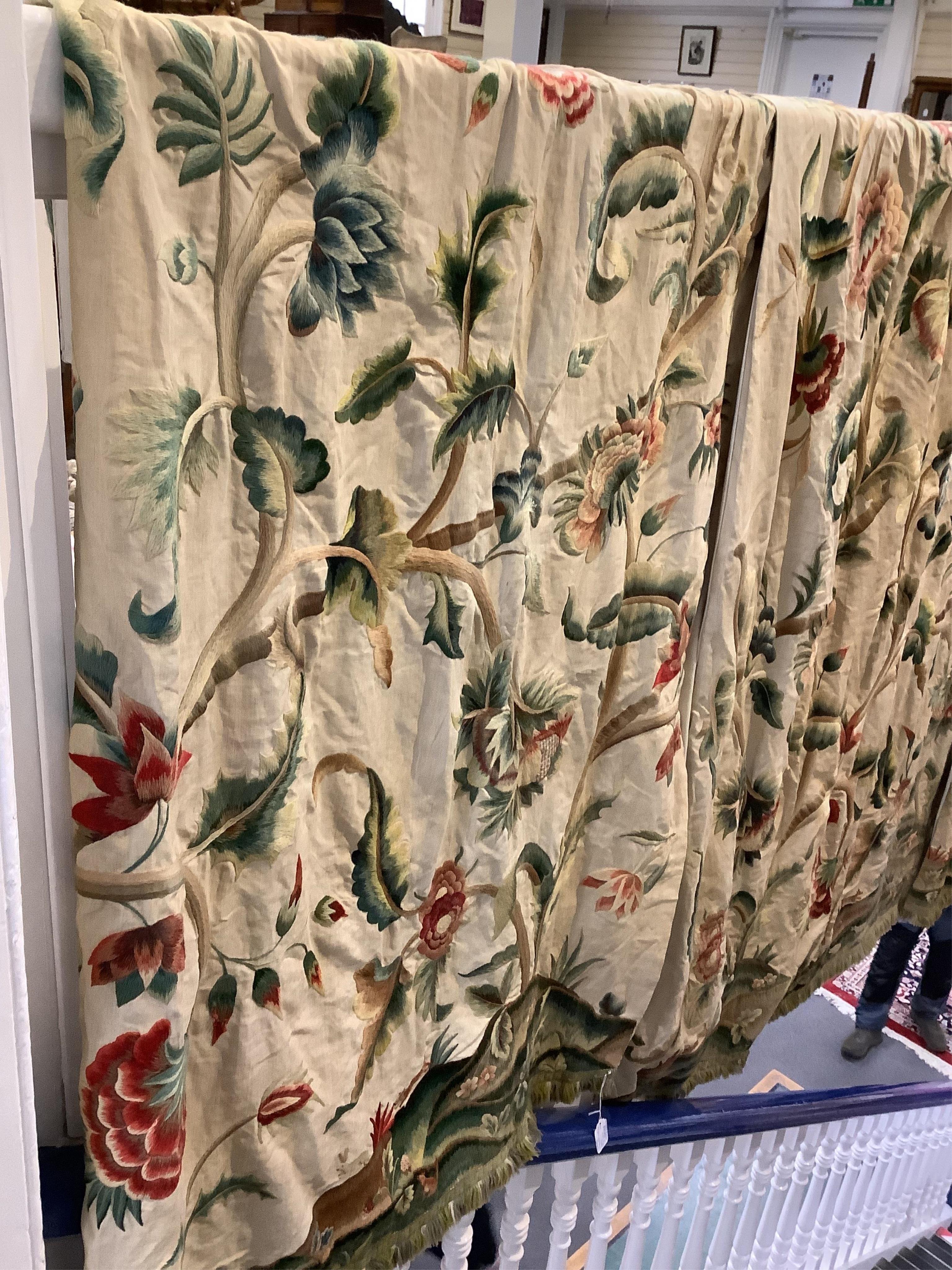 Six 20th century crewel work ‘Tree of Life’ cream linen curtains. Worked at the base in coloured wools depicting a pastoral scene of a shepherd playing a flute amongst sheep, deer, squirrels and flowers with a dog chasin